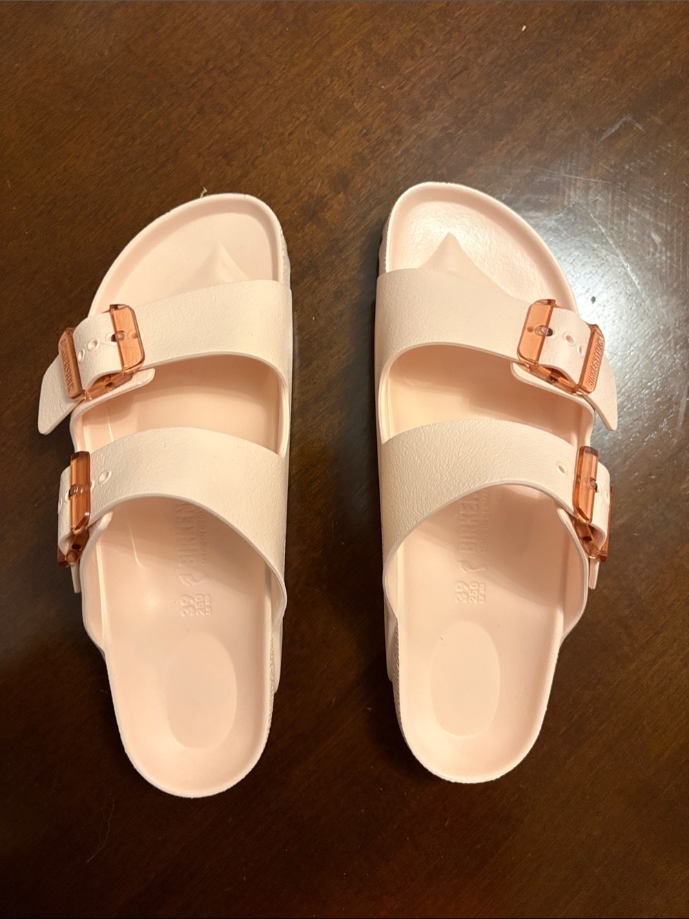 Birkenstock Arizona women’s Two-Strap Slides in Pale Pink with Rose-Gold Buckles